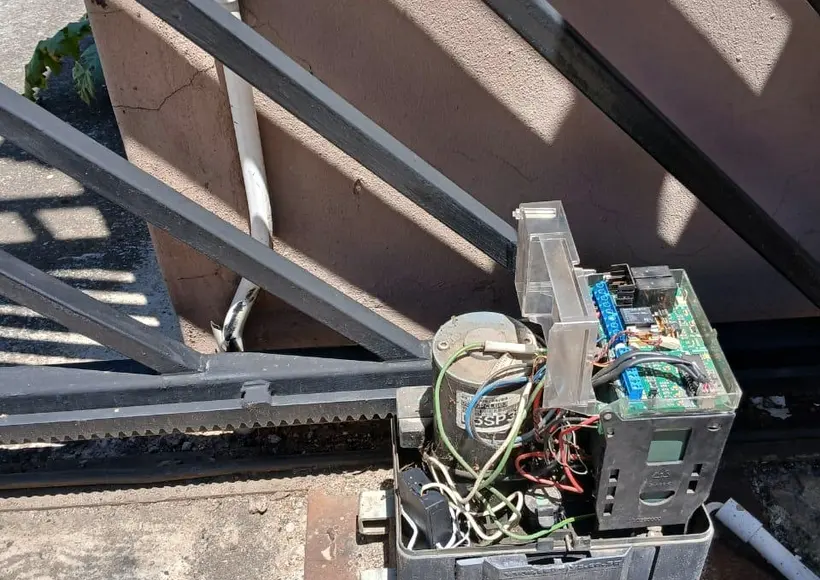 Old opened-up gate motor with exposed wiring